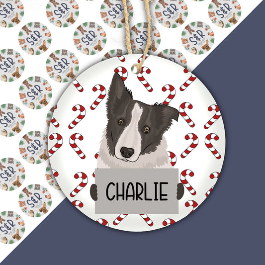 A ceramic Christmas ornament featuring a drawing of a Border Collie dog with a festive design in the background.