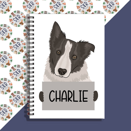A personalised notebook with a graphic of a Border Collie dog on the front cover, with the name 'Charlie' written on the front.