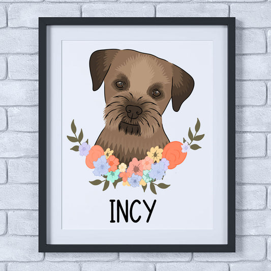 A framed print of a Border Terrier dog with a floral pattern around it, on a wall.