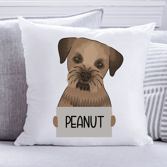 A square-shaped cushion featuring a printed image of a Border Terrier dog with the text 'PEANUT' on a sign it is holding.