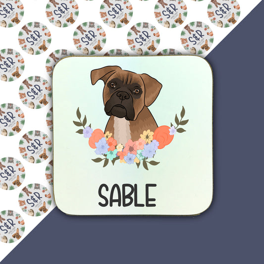 A square coaster with a printed image of a Boxer dog surrounded by a floral pattern, with the word 'SABLE' at the bottom.