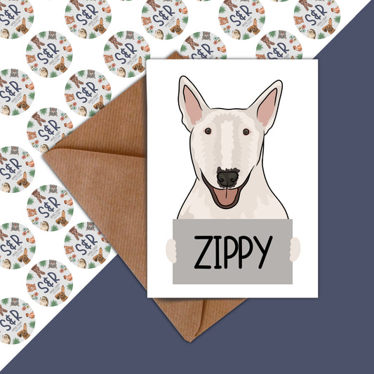 A birthday card featuring an illustration of a Bull Terrier dog with the name 'Zippy' written on the front, placed on a background with various patterns.