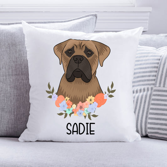 A square-shaped cushion with a white background featuring an illustration of a Bullmastiff dog surrounded by a floral pattern. The cushion has the name 'SADIE' printed on it.