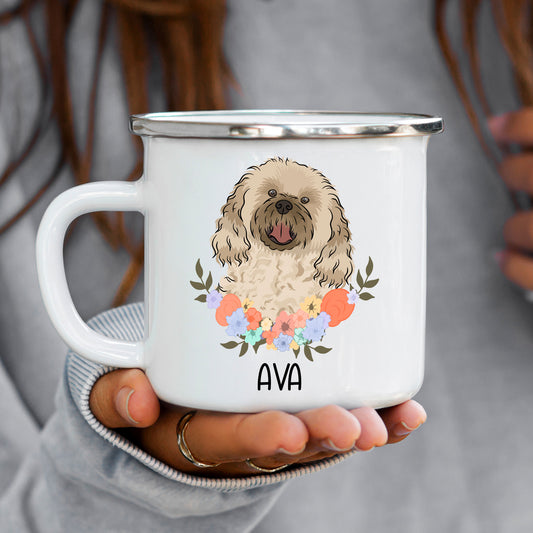 A white enamel mug with a printed Cavachon dog and flowers design, with a name 'AVA' personalised on the front.