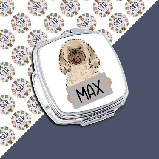 A personaliSed compact mirror with an illustration of a cavachon dog on the front, with the name 'Max' printed below the image.