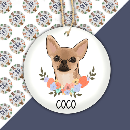 A ceramic Christmas decoration featuring a floral design with a cartoon image of a Chihuahua dog in the center.