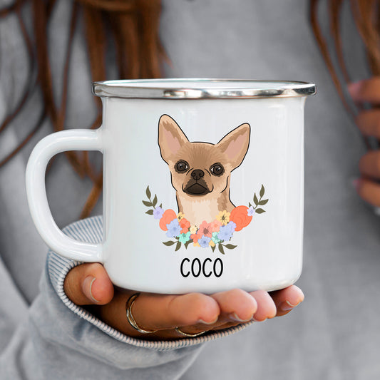 A person holding a white enamel mug with a Chihuahua dog illustration and the name 'Coco' printed on the front.