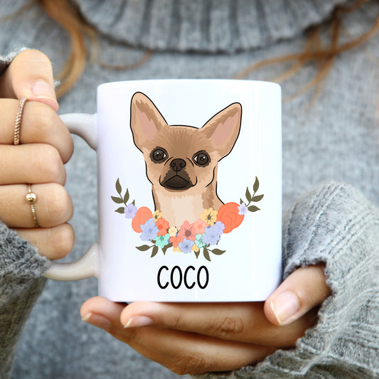 A white coffee mug with a colourful illustration of a Chihuahua dog surrounded by a floral pattern, with the text 'COCO' below the image.