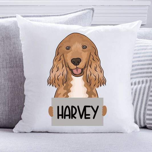 A square-shaped, white dog cushion featuring an illustration of a Cocker Spaniel dog with the text 'Harvey' on a tag.