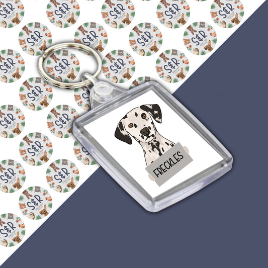 A personalised keyring with an image of a Dalmatian dog on a round acrylic charm, with the name 'Daisy' printed on the backdrop.