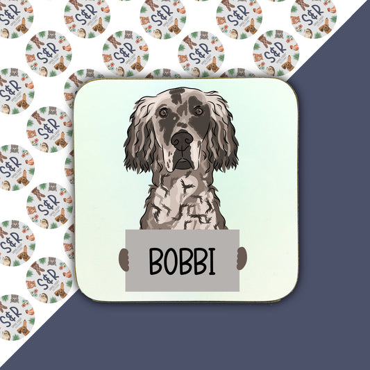 A personalised square coaster with an illustration of an English Setter dog, with the name 'BOBI' below the image.