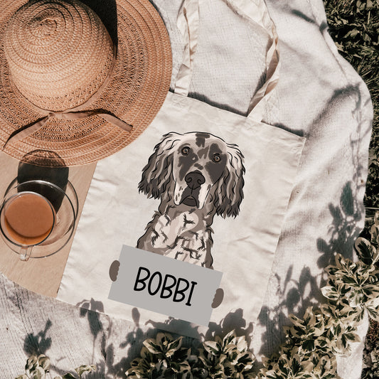 A white cotton tote bag with a printed grayscale illustration of an English Setter dog and the name 'BOBBI' below it.