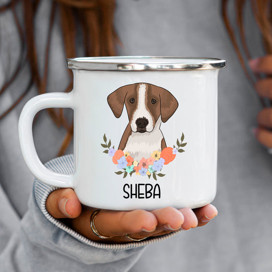 A white enamel mug with a printed image of a foxhound dog in the center surrounded by a floral pattern. The mug has the name 'Sheba' printed on it.