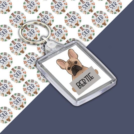 A personalised French Bulldog keyring with an image of a French Bulldog on a round acrylic casing with a personalised name 'Bertie'.
