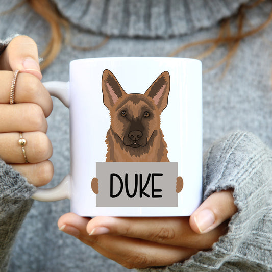 A white coffee mug with a double-sided illustration of a German Shepherd dog. The mug has the text 'Duke' printed on the front.