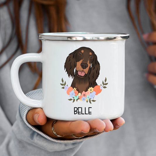 A white enamel mug with a printed illustration of a brown dog, presumably a Gordon Setter, surrounded by a floral wreath. The mug has the name 'Belle' printed on the front.