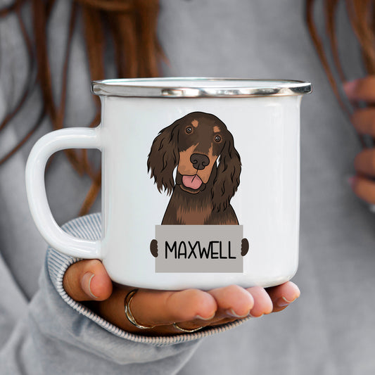 A white enamel mug with a personalised illustration of a dog's face, specifically a Gordon Setter, with the name 'Maxwell' underneath.