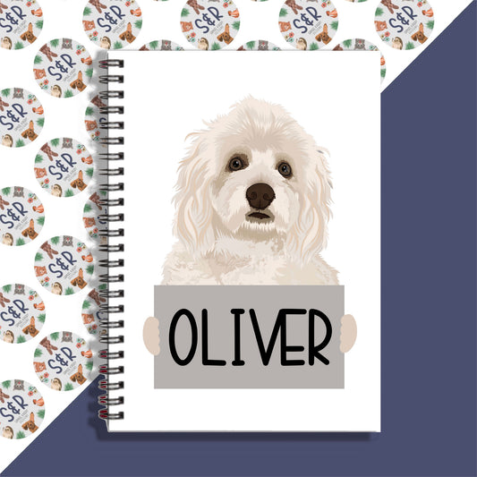 A notebook with a spiral binding featuring a graphic of a Havanese dog on the front cover, with the name 'Oliver' printed on the page.