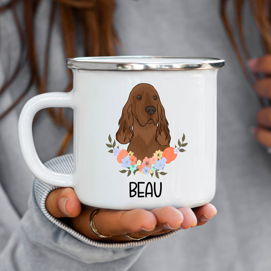A white enamel mug with a printed illustration of an Irish Setter dog surrounded by a floral wreath, with the text 'BEAU' at the bottom.