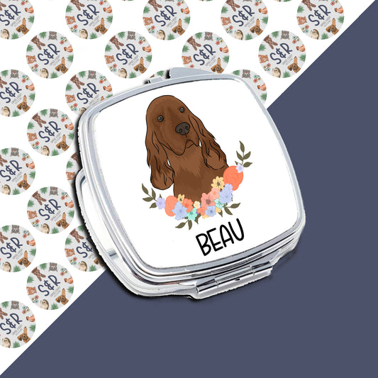 A personalised compact mirror featuring an illustration of an Irish Setter dog with a floral design in the background.