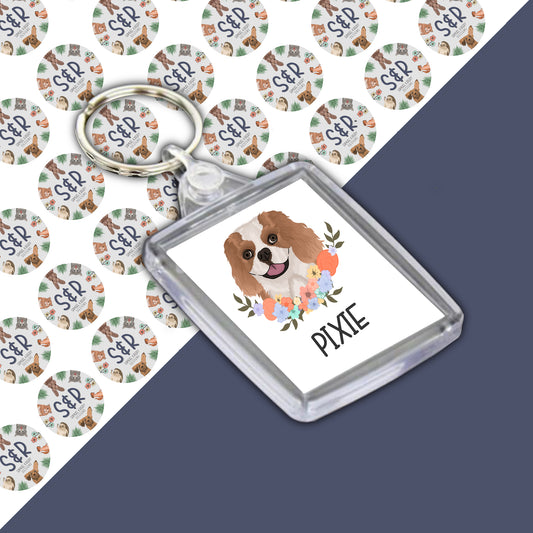 A personalised King Charles Spaniel keyring with an acrylic casing, featuring an image of a dog on the front.