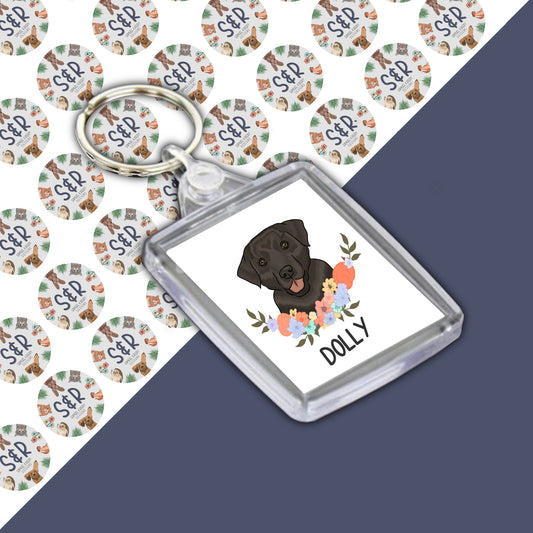 A personalised Labrador keyring with an illustration of a dog on a round acrylic casing, featuring the text 'Dolly' on the keyring.