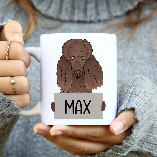 A person holding a novelty coffee mug with a cartoon illustration of a poodle dog on it.