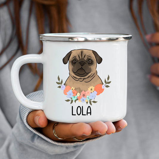 A white enamel mug with a printed graphic of a pug dog surrounded by a floral pattern, with the name 'LOLA' at the bottom.