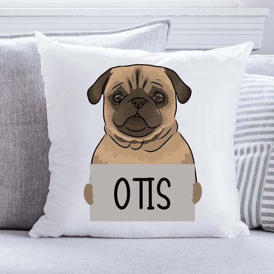 A personalised cushion featuring an illustration of a pug dog with the name 'Otis' printed on it, placed on a sofa.