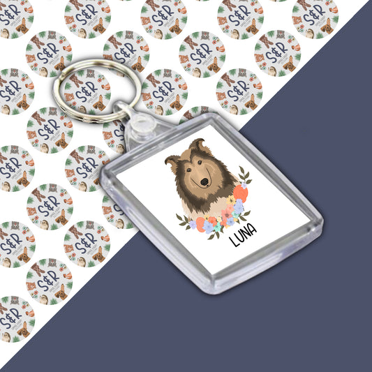 A personalised keyring featuring an illustration of a Rough Collie dog on a green and white background with the text 'LUNA' on the keyring.