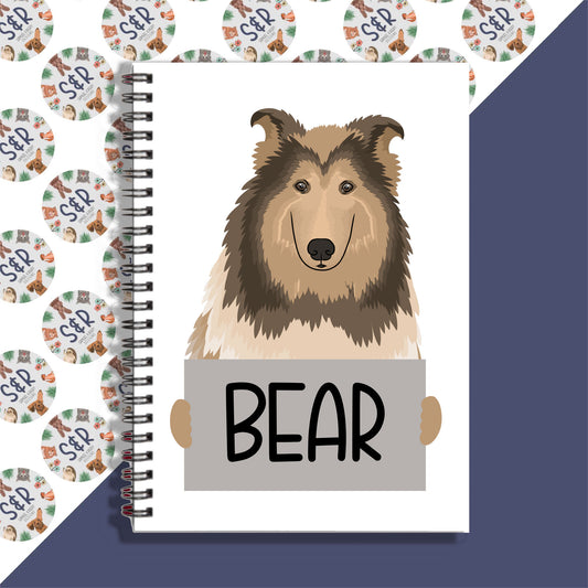 A notebook with a drawing of a Rough Collie dog on the cover, with the word 'BEAR' written below the image.