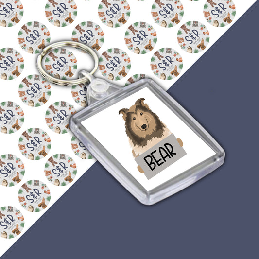 A double-sided personalised keyring featuring an illustration of a Rough Collie dog on a green and white background on one side, with a custom name 'BEAR' on a white background on the other side.