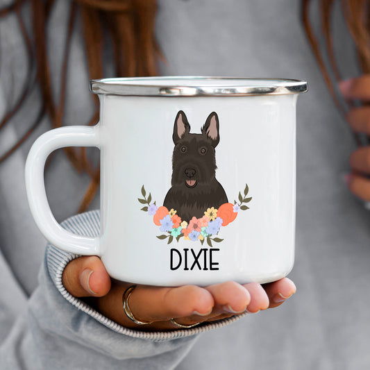 A white enamel mug with a black and grayscale image of a Scottish Terrier dog, surrounded by a floral pattern.