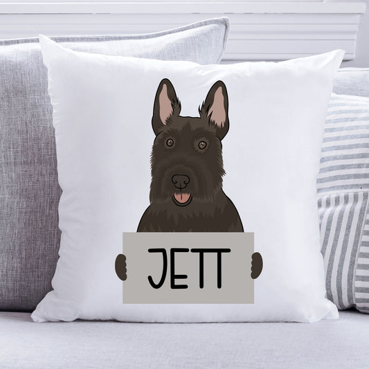 A square-shaped white cushion with an illustration of a Scottish Terrier dog at the top, and the name 'Jett' printed below the image.