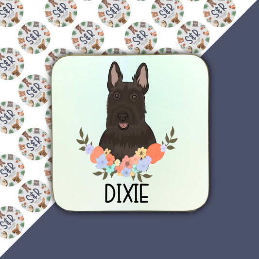 A square coaster with an illustration of a Scottish Terrier dog surrounded by a floral pattern.