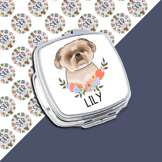 A personalised compact mirror with a sublimated design featuring a Shih Tzu dog at the centre surrounded by a floral pattern, with the name 'Lily' at the bottom.