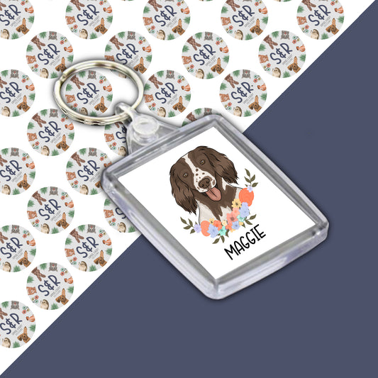 A personalised acrylic keyring featuring an illustration of a Springer Spaniel dog with the name 'Maggie' on the tag.