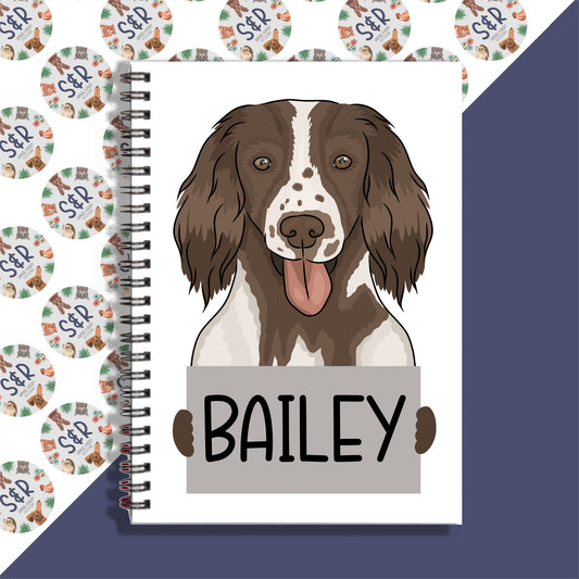 A personalised notebook with a Springer Spaniel dog illustration on the cover, featuring the name 'Bailey'.