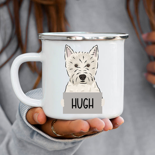 A white ceramic enamel mug with a graphic of a Westie dog printed on the side, held in a person's hand.