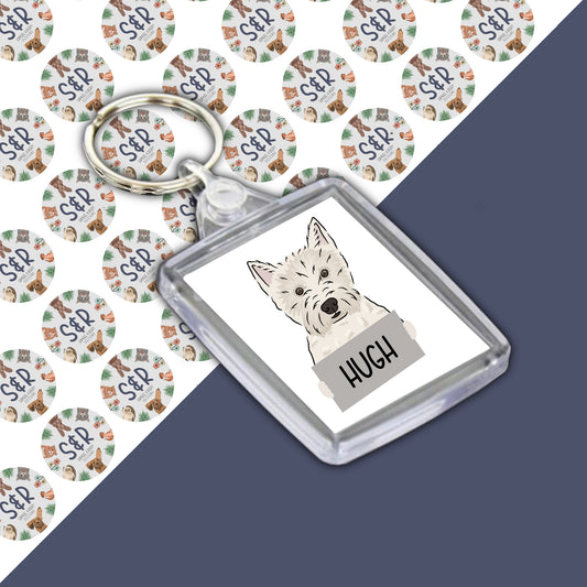 A personalised double-sided acrylic keyring with an image of a Westie dog and the name 'Hugh' printed on it.
