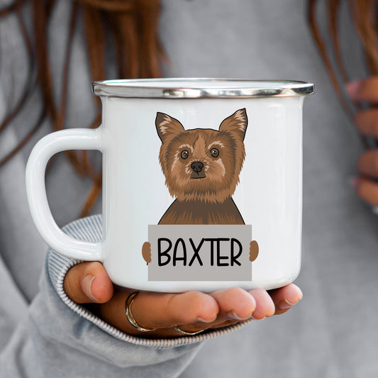 A white enamel mug with a personalised inscription that reads 'Baxter' alongside an illustration of a Yorkshire Terrier dog.
