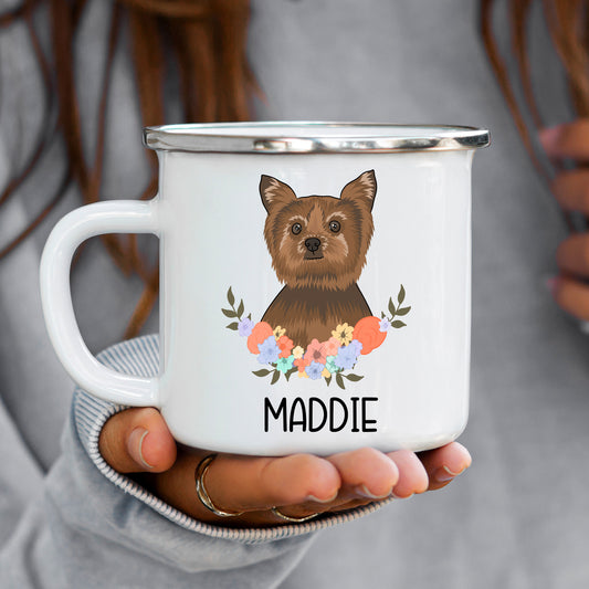 A white enamel mug with a printed image of a Yorkshire Terrier dog breed, surrounded by a floral pattern with the name 'MADDIE' underneath the image.