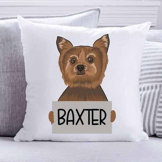 A personalised cushion featuring an illustration of a Yorkshire Terrier dog with the name 'Baxter' printed on it, sitting in a white square frame.